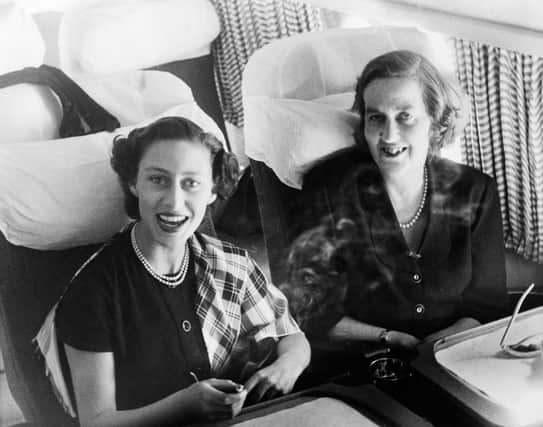Princess Margaret laughing delightedly and holding a cigarette, seated beside the Marchioness of Salisbury as they took tea in the Comet during the flight.