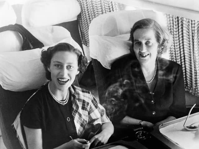 Princess Margaret laughing delightedly and holding a cigarette, seated beside the Marchioness of Salisbury as they took tea in the Comet during the flight.