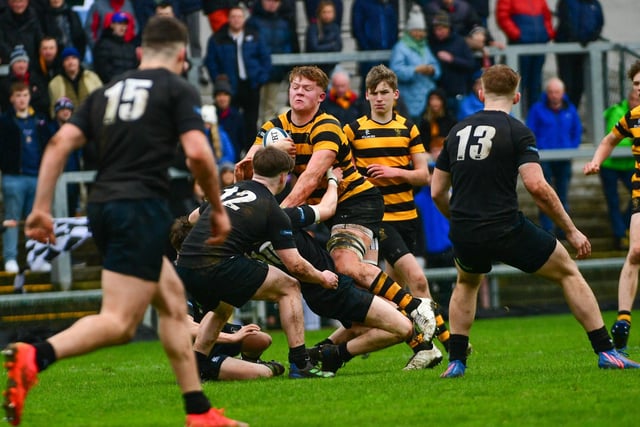 Bryn Ward of RBAI is tackled by James McConnell of Campbell College