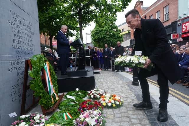 U2's Larry Mullen Jr lays a wreath during a ceremony at the Memorial to the victims of the Dublin and Monaghan bombings on Talbot Street in Dublin