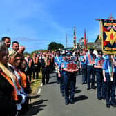 An annual large-scale iteration of the smaller Sunday parades at Drumcree, on July 7, 2019; the marchers gather each Sunday atop Drumcree hill, and march to the police line at the bottom in a symbolic protest against the blocking of the return route into Portadown
