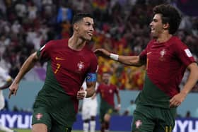 Portugal's Cristiano Ronaldo, left, celebrates with teammate Joao Felix after scoring from the penalty spot his side's opening goal against Ghana
