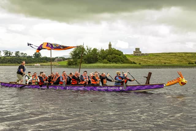 Officers of County Fermanagh Grand Orange Lodge with other brethren row their way down Lower Lough Erne past Devenish Island to the Twelfth demonstration in Ballinamallard