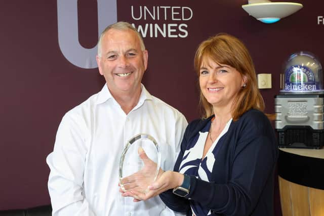 United Wines head of finance Siobhan McSorley from Donaghmore has been recognised for 20 years’ service at the Craigavon-based drinks company. Siobhan was presented with a commemorative plaque and a gift voucher from United Wines managing director Martin McAuley to mark two decades at the company’s County Armagh base. Credit: Darren Kidd/Presseye