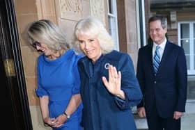 Queen Camilla gives a wave to the cameras as she arrives at Hillsborough Castle