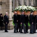 The coffin of Sir Bobby Charlton is carried by pallbearers out of Manchester Cathedral after the funeral service. Manchester United and England great Sir Bobby Charlton died aged 86 in October. (Photo by Martin Rickett/PA Wire)