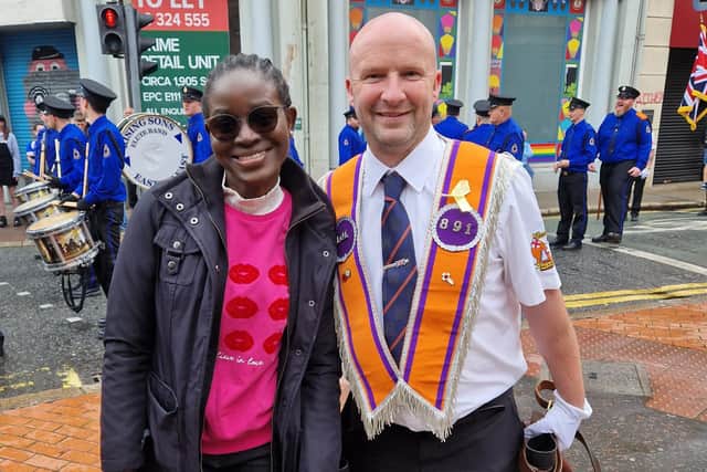 Favour Okpohs, a Nigerian student at Ulster University, poses for a picture with Orangeman Mark Davison from LOL 891