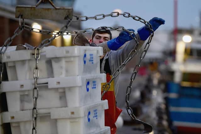 Trawler men unload their catch at Peterhead fish market, Scotland; there have been reports of imports of Scottish fish being turned back at Belfast port