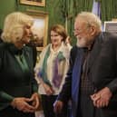 Queen Camilla speaking with caontemporary poet Micheal Longley as she attends an event hosted by the Queen's Reading Room to mark World Poetry Day at Hillsborough Castle
