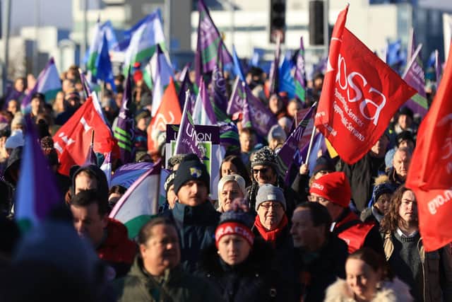 Public sector workers walk from the picket line at the Royal Victoria Hospital to a rally at Belfast City Hall, as an estimated 150,000 workers take part in walkouts over pay across Northern Ireland.