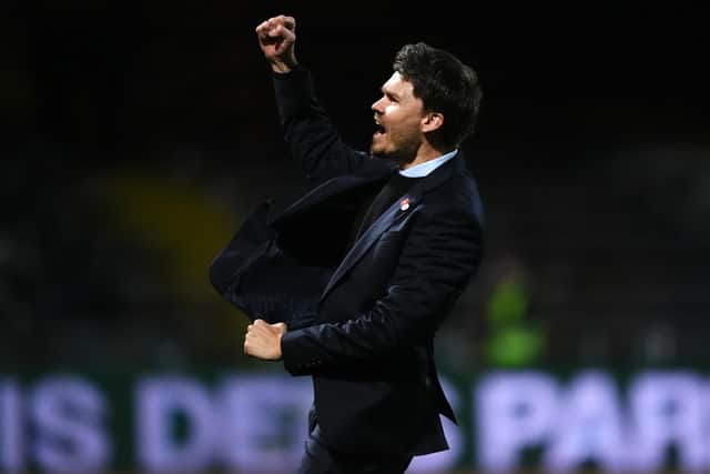 Rangers manager Danny Rohl celebrates in front of the fans after the final whistle in the William Hill Premiership match at Dens Park, Dundee
