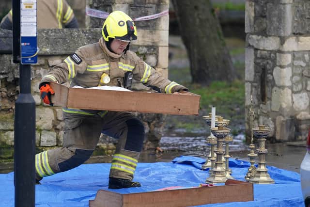 Firefighters remove items from St Mark's Church in Hamilton Terrace, St John's Wood, London, which has been destroyed by a blaze which began in the early hours of the morning. 80 firefighters attended the heritage-listed north-west London church that has been described as an "architectural and historical treasure"