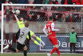 Cliftonville goalkeeper Nathan Gartside can't stop Lyndon Kane from opening the scoring for Coleraine at Solitude