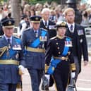 Prince William, Prince of Wales, King Charles III, Prince Richard, Duke of Gloucester, Anne, Princess Royal and Prince Harry, Duke of Sussex walk behind the coffin during the procession for the Lying-in State of Queen Elizabeth II