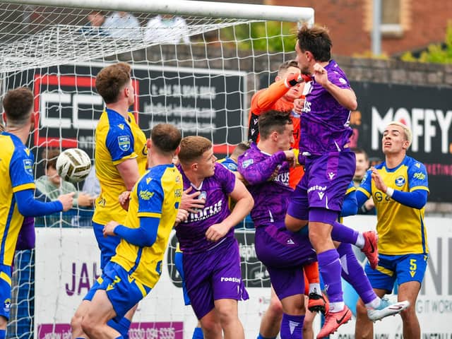Joe Thomson heads in Coleraine's third goal on Sunday during victory over Bangor. (Photo by Andrew McCarroll/Pacemaker Press)