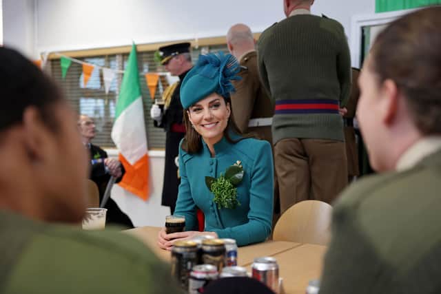 The Princess of Wales meets members of the Irish Guards and enjoys a glass of Guinness during a visit to the 1st Battalion Irish Guards for the St Patrick's Day Parade, at Mons Barracks in Aldershot.