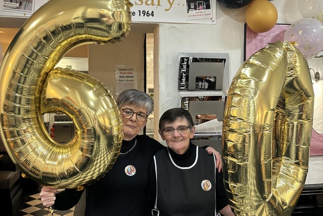 Heralds at 22 staff Louise and Maggie getting in celebration swing. Maggie has been at Herald's for over 25 years having started in the cafe in 1999