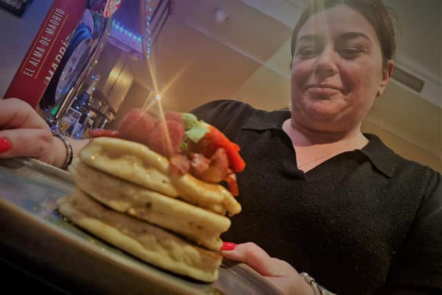 Front of house manager at Safari Kerry Devlin delivers a pancake stack for breakfast