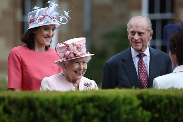 Queen Elizabeth II, Theresa Villiers, Secretary of State for Northern Ireland (L) and Prince Philip, Duke of Edinburgh meet guests during a garden party in the grounds of Hillsborough Castle on June 24, 2014 near Belfast, Northern Ireland. The Royal party are visiting Northern Ireland for three days.  (Photo by Peter Macdiarmid/Getty Images)