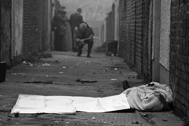 25/10/82: The body of Catholic man Joseph Donegan lies in an entry off the Shankill Road in west Belfast after being murdered by members of the Shankill Butchers. Photo: Pacemaker