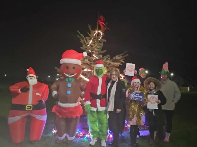 Pictured celebrating the arrival of the Christmas tree are Dhu Varren residents and local business owners Leeanne Montgomery, Louise Vickers, Aimee Anderson, Declan Anderson, Biddy Fleming, Claire Cairns, Jessica Mitchell and Elizabeth Brown