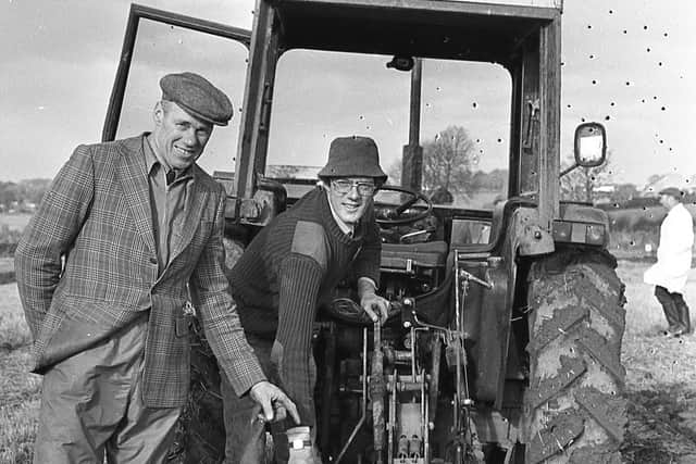 Hugh Barr, a three times world champion, with his son John, one of the competitors at the Ulster International Ploughing Match which was held at Moira in November 1980. Picture: Farming Life archives/Darryl Armitage
