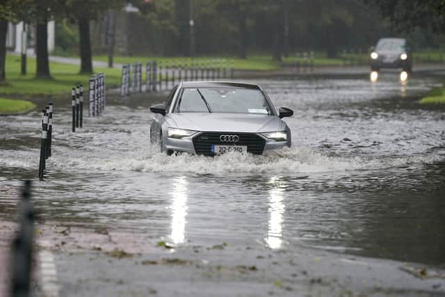 A car driving through floodwater in Cork. Weather warnings will come into force as the UK and Ireland brace for the arrival of Storm Agnes, which will bring damaging winds and big stormy seas.