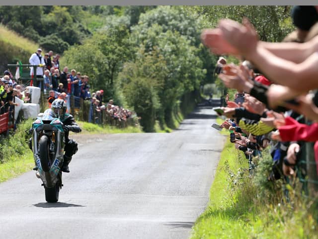 The fans applaud Michael Dunlop after he won the second Supersport race at the Armoy Road Races on his MD Racing Yamaha