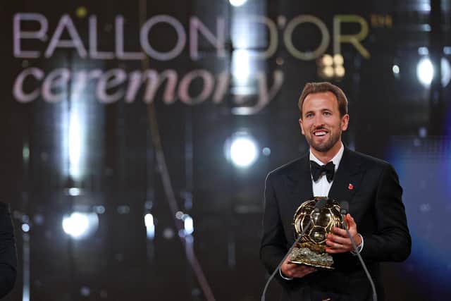 England and Bayern Munich forward Harry Kane reacts after receiving the Ballon d'Or award. (Photo by FRANCK FIFE / AFP via Getty Images)