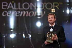 England and Bayern Munich forward Harry Kane reacts after receiving the Ballon d'Or award. (Photo by FRANCK FIFE / AFP via Getty Images)