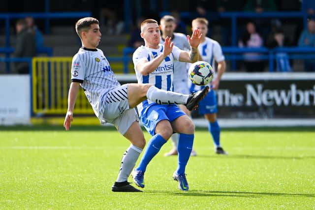 Coleraine midfielder Josh Carson and Newry City counterpart Jordan Mooney in action at The Showgrounds