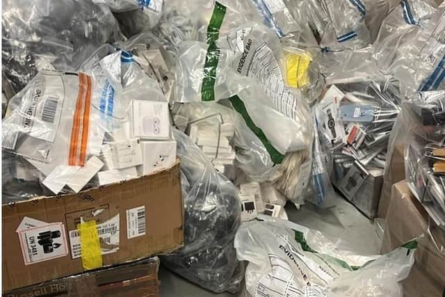 Some of the counterfeit iPhones and AirPods that were among goods worth £600,000 seized during searches in Northern Ireland