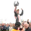 Michael Dunlop is hoisted aloft after winning an emotional 250cc race at the North West 200 in 2008 less than 48 hours after his father Robert was killed in a crash at the event
