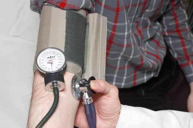 Blood pressure test being carried out by a health professional. Photo: PA