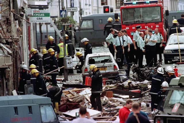 Police officers and firefighters inspecting the damage caused by the Omagh Bomb in 1998. Twenty-nine people, including a woman pregnant with twins, were killed when a car bomb exploded in the Co Tyrone town in 1998. Photo: Paul McErlane/PA Wire