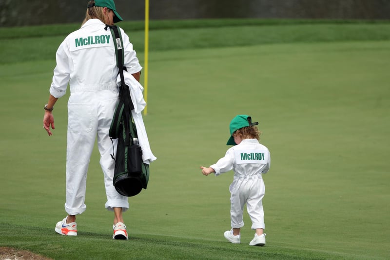 AUGUSTA, GEORGIA - APRIL 05: Rory McIlroy of Northern Ireland wife, Erica Stoll, walks on the first green with their daughter Poppy McIlroy on the first hole during the Par 3 contest prior to the 2023 Masters Tournament at Augusta National Golf Club on April 05, 2023 in Augusta, Georgia. (Photo by Patrick Smith/Getty Images)
