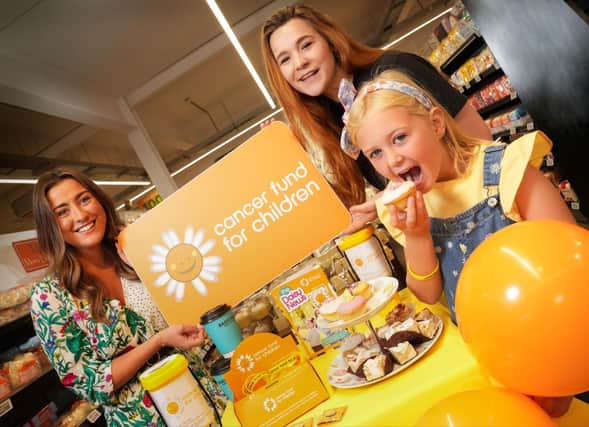Laura Thompson, Henderson Group, and Alex Murdock from Cancer Fund for Children with service user Sophia McBride, enjoying coffee and sweet treats in aid of Cancer Fund for Children.