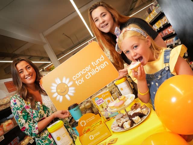 Laura Thompson, Henderson Group, and Alex Murdock from Cancer Fund for Children with service user Sophia McBride, enjoying coffee and sweet treats in aid of Cancer Fund for Children.