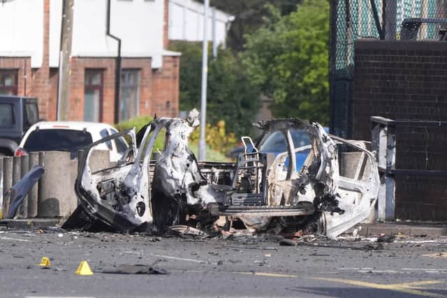 The remains of a hijacked delivery driver's car after it was use in the second dissident republican proxy bomb attack on a police station in two months. Photo: Niall Carson/PA Wire