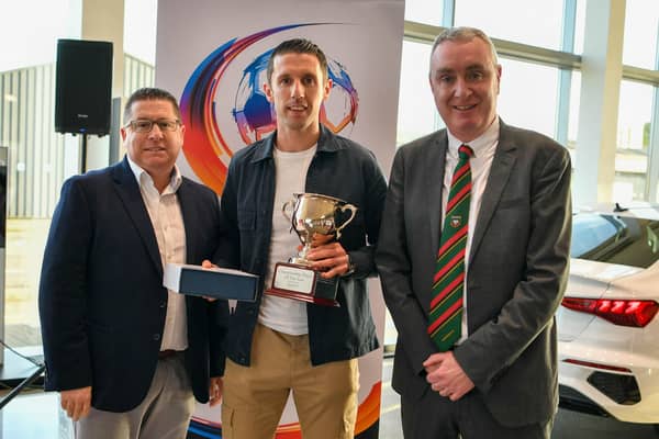 Championship Footballer of the Year winner Gary Thompson receives the award from Gerard Lawlor and Castlereagh Glentoran Supporters Club member Dan Boyd. PIC: Andrew McCarroll/ Pacemaker Press
