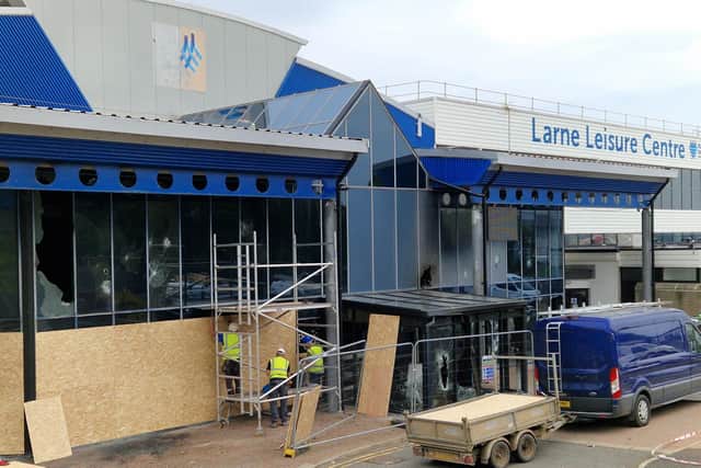 Workers boarding up the smashed and burned leisure centre yesterday