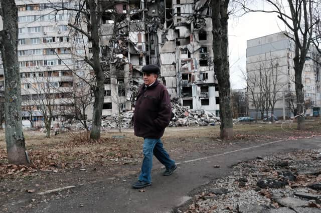 A man walks through a neighbourhood destroyed by the Russians on the outskirts of Kharkiv in Ukraine