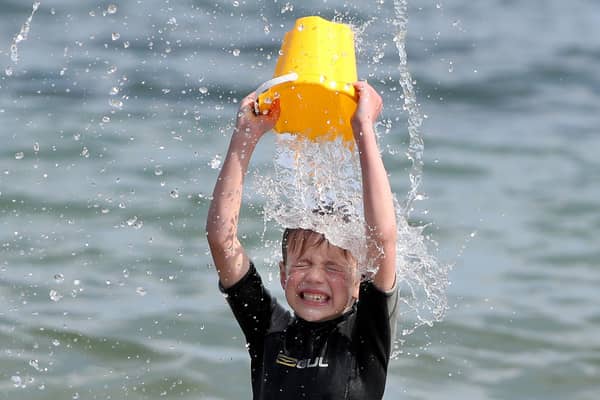 Max Halliwell cools down in the sea at Helens Bay. Photograph by Declan Roughan / Press Eye