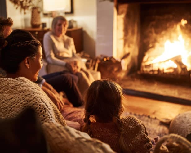 Family Gathered Around Fireplace in Cozy Living Room
