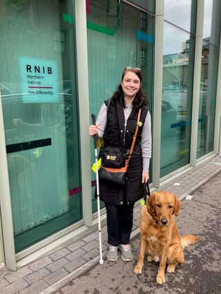 Dawn Hopper with guide dog Micky outside the RNIB offices in Belfast