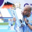 Manchester City manager Pep Guardiola kisses the Premier League trophy after the Premier League match at the Etihad Stadium, Manchester. PIC: Martin Rickett/PA Wire.