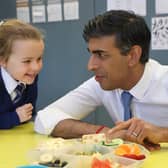 Prime Minister Rishi Sunak speaking to primary 2 students as they take their healthy break during his visit to  Glencraig Integrated Primary School in Holywood, Co Down