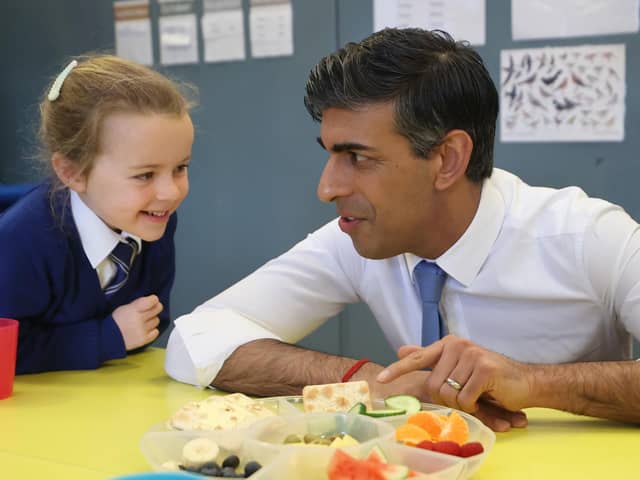 Prime Minister Rishi Sunak speaking to primary 2 students as they take their healthy break during his visit to  Glencraig Integrated Primary School in Holywood, Co Down