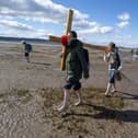 Pilgrims carrying wooden crosses to Lindisfarne in Northumberland on Good Friday. Pilgrims walk to Lindisfarne, Northumberland on Good Friday. It’s both an island and not an island. ​I found a common purpose among those who were there, however much their motivations for coming may have varied. Photo: Jane Barlow/PA Wire