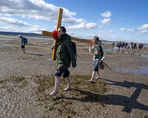 Pilgrims carrying wooden crosses to Lindisfarne in Northumberland on Good Friday. Pilgrims walk to Lindisfarne, Northumberland on Good Friday. It’s both an island and not an island. ​I found a common purpose among those who were there, however much their motivations for coming may have varied. Photo: Jane Barlow/PA Wire